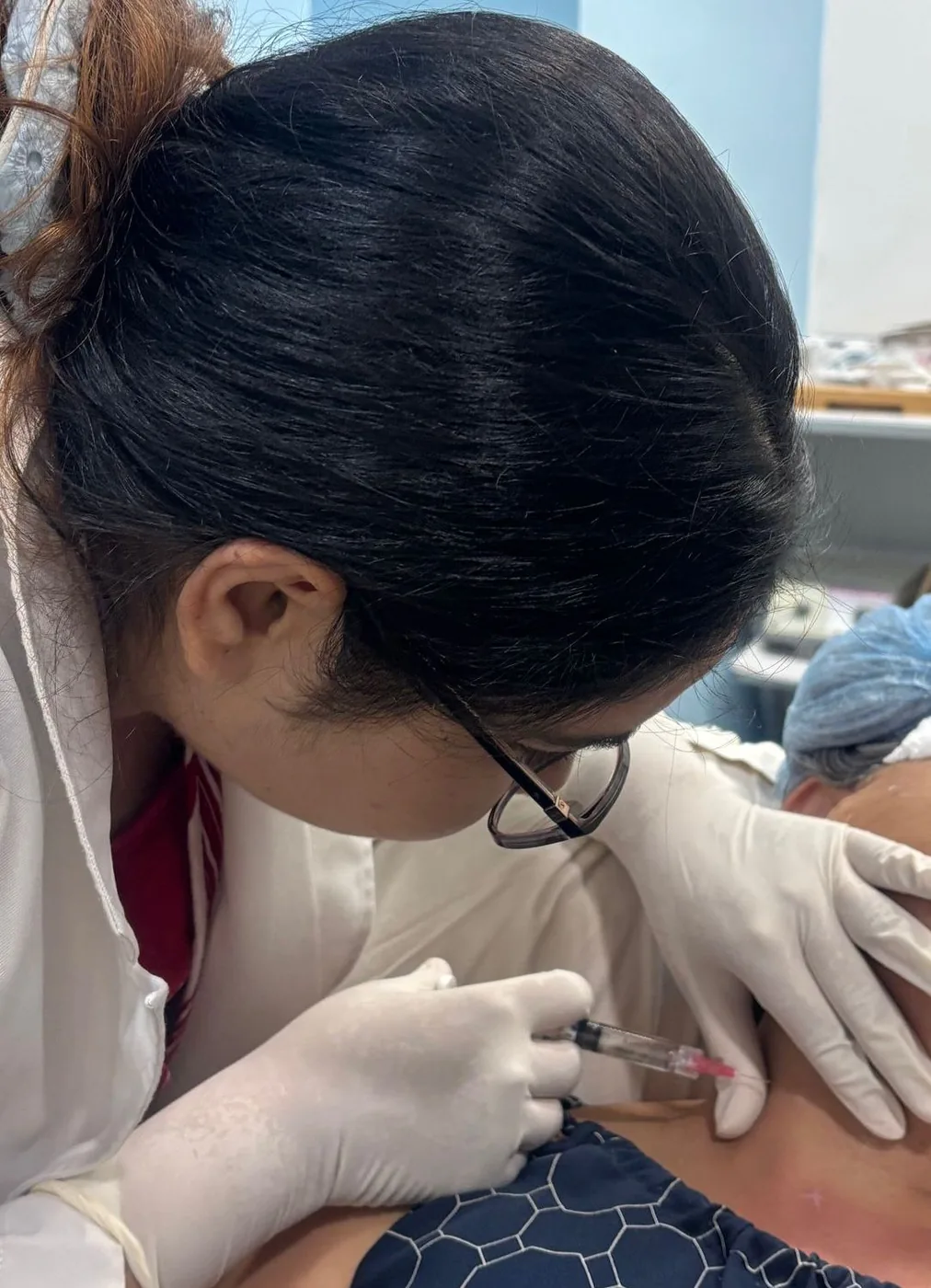 Dr. Pooja Shrivastava performing an injection treatment.